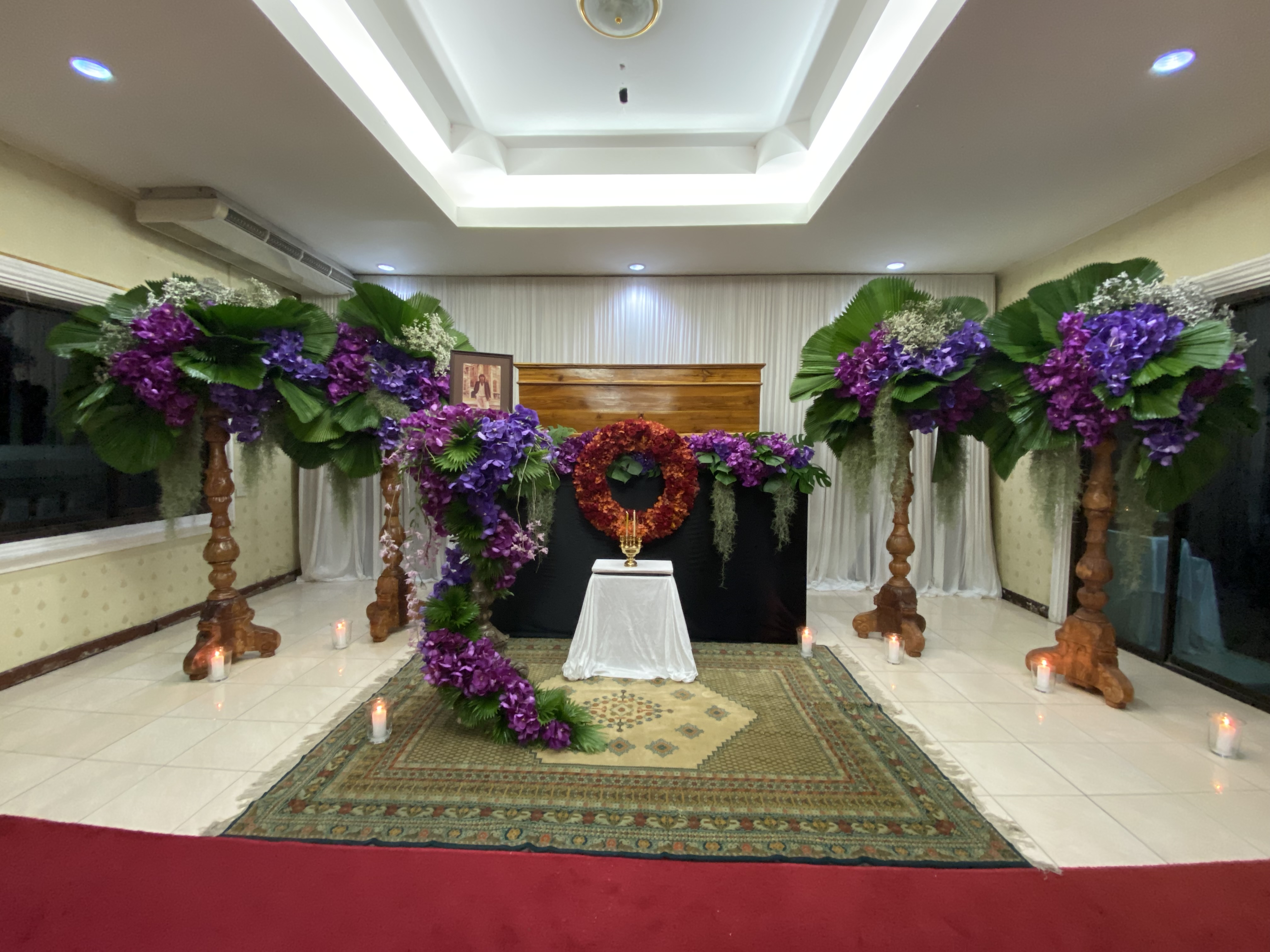 Indoor ceremony with purple hydrangeas and candlelight