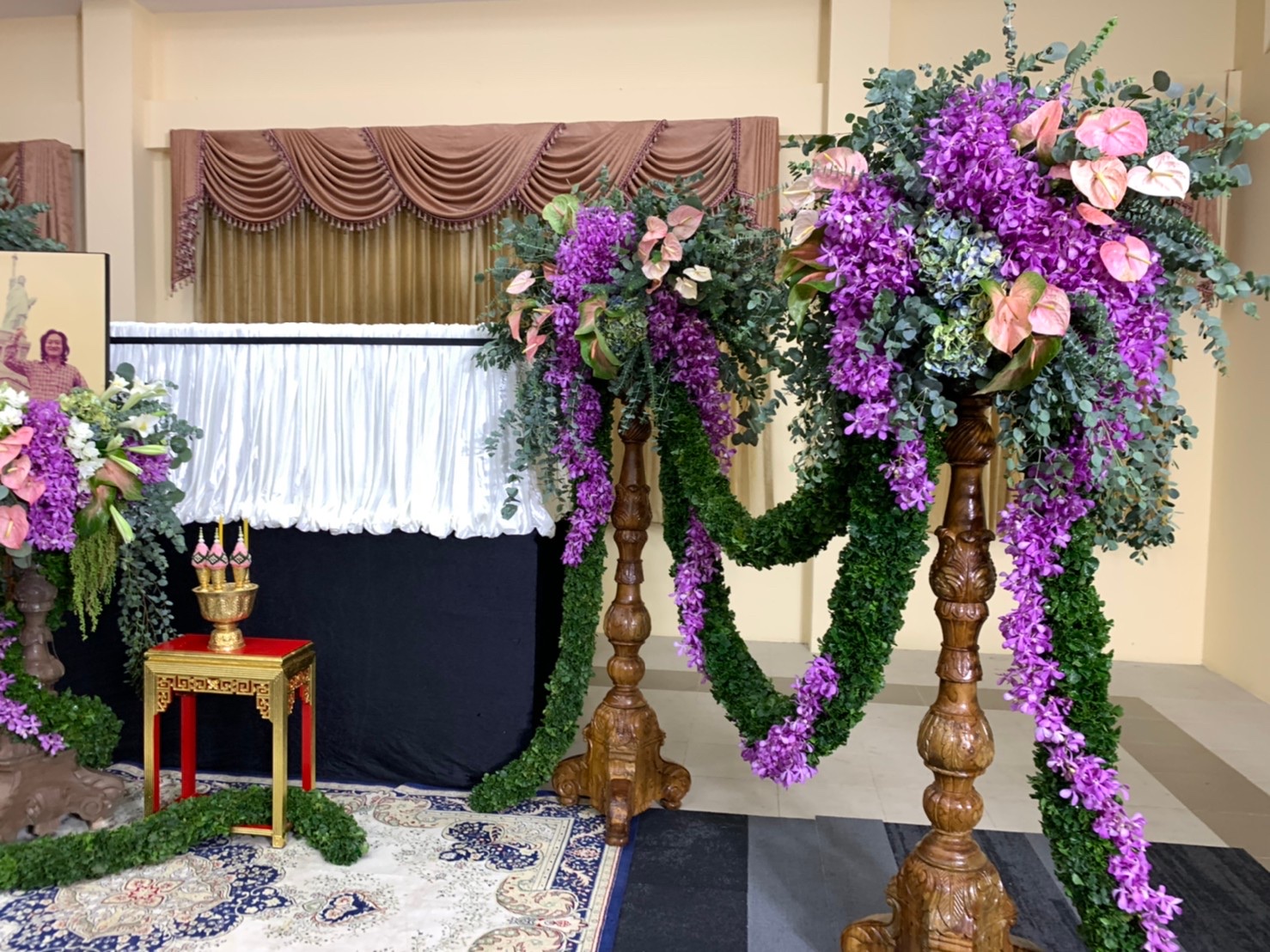 Cascading purple orchid and hydrangea arrangements on carved stands