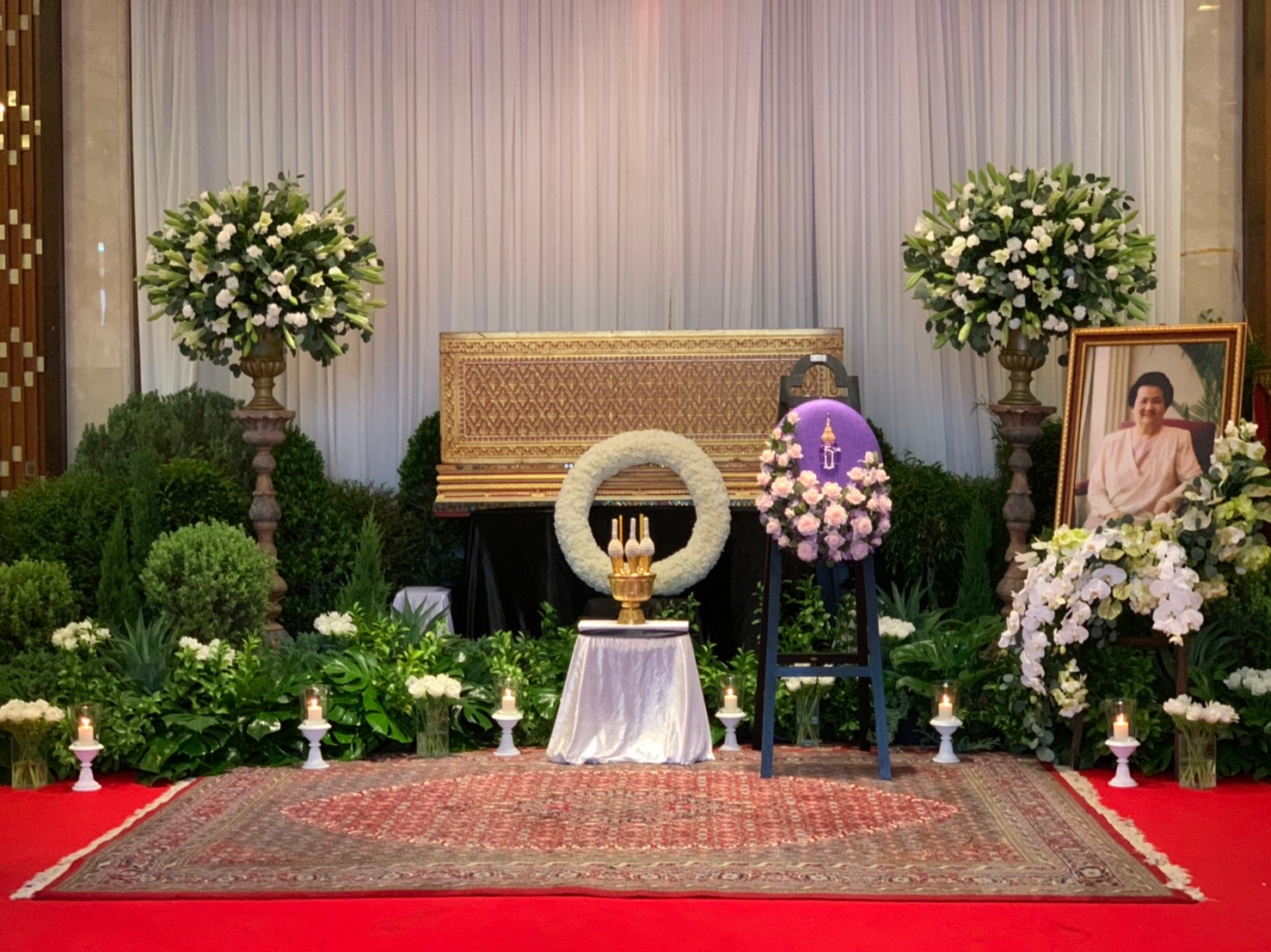 Wide view of elegant ceremony hall with royal purple wreath