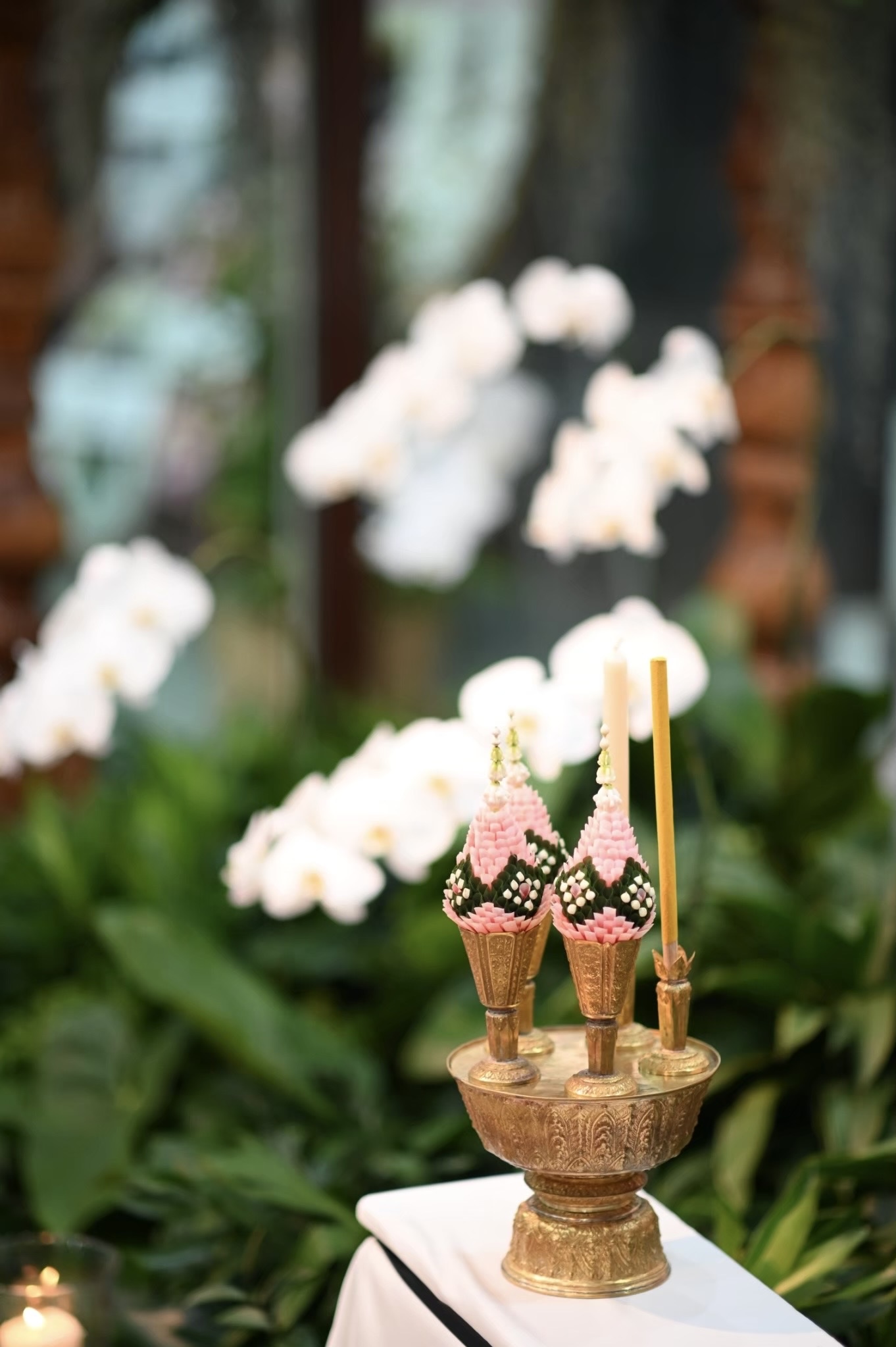 Thai ritual krathong with white orchid bokeh backdrop