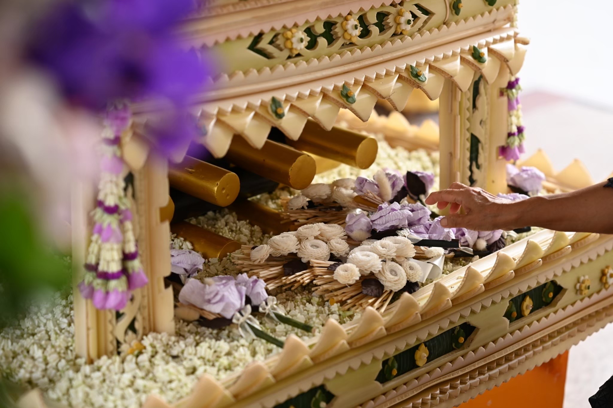 Intricate banana-leaf cremation casket detail with jasmine garlands