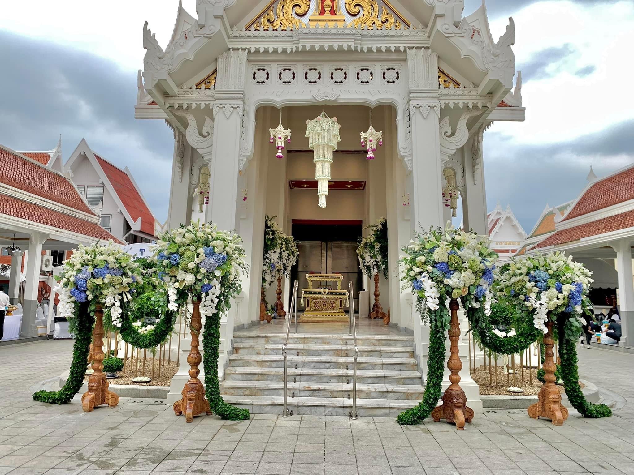 Royal temple entrance adorned with blue and white floral arch