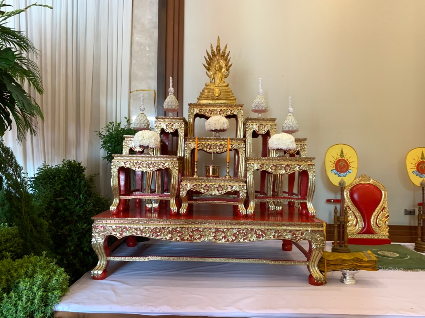 Golden Buddhist altar with tiered lacquer offering tables